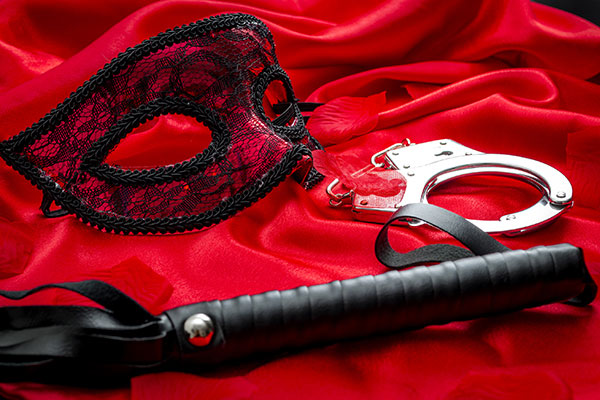 mask, handcuffs and whip