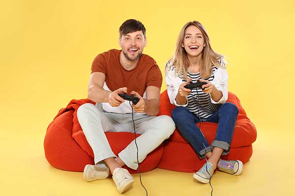 Gamer couple playing games on sofa