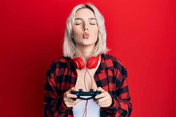 Gamer girl with gaming pad blowing kiss
